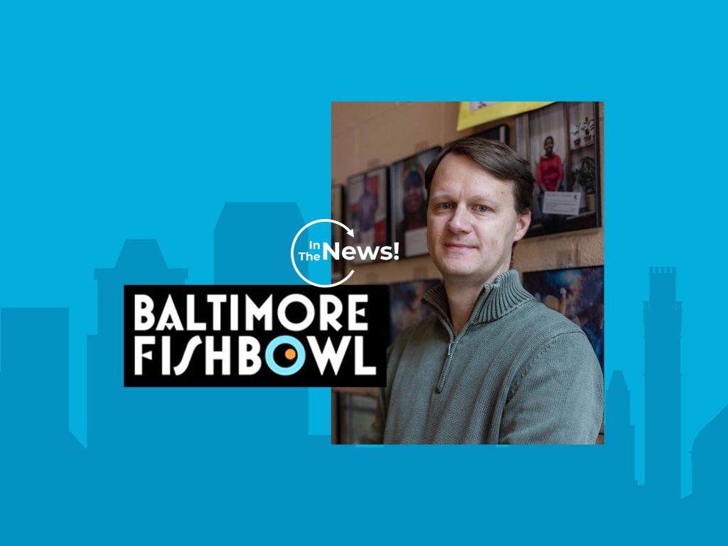 A photo of Executive Director, Jason Woody with the logo for "Baltimore Fishbowl" and a caption of "In the News" overlaid on a photo of the Baltimore Skyline